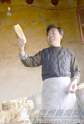 看著自己做的火燒李吉文像端詳藝術(shù)品